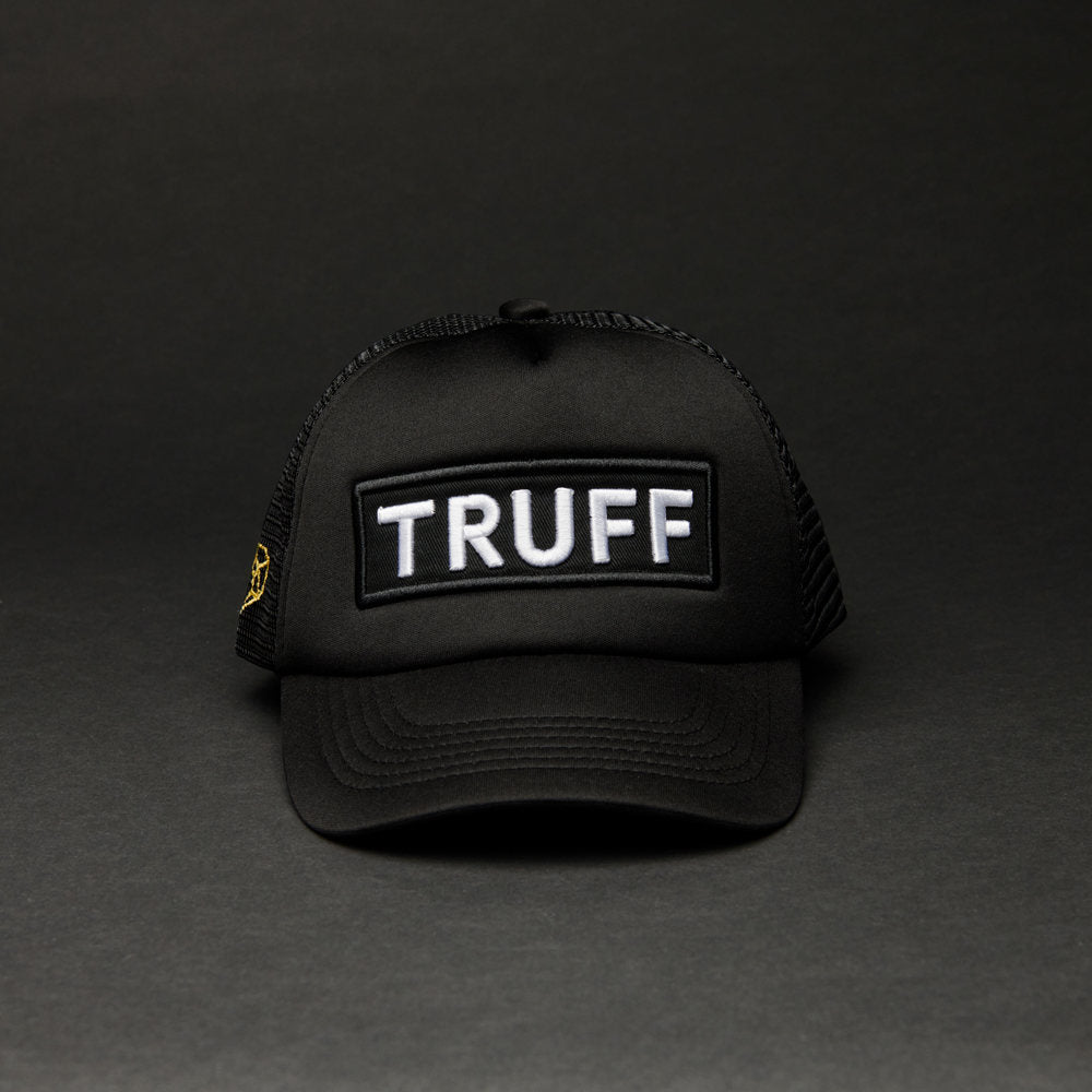 TRUFF trucker hat with logo in front on a black background.