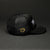 Side angle of the TRUFF trucker hat with logo in front on a black background.
